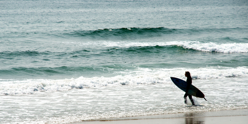 Surfer standing in waves
