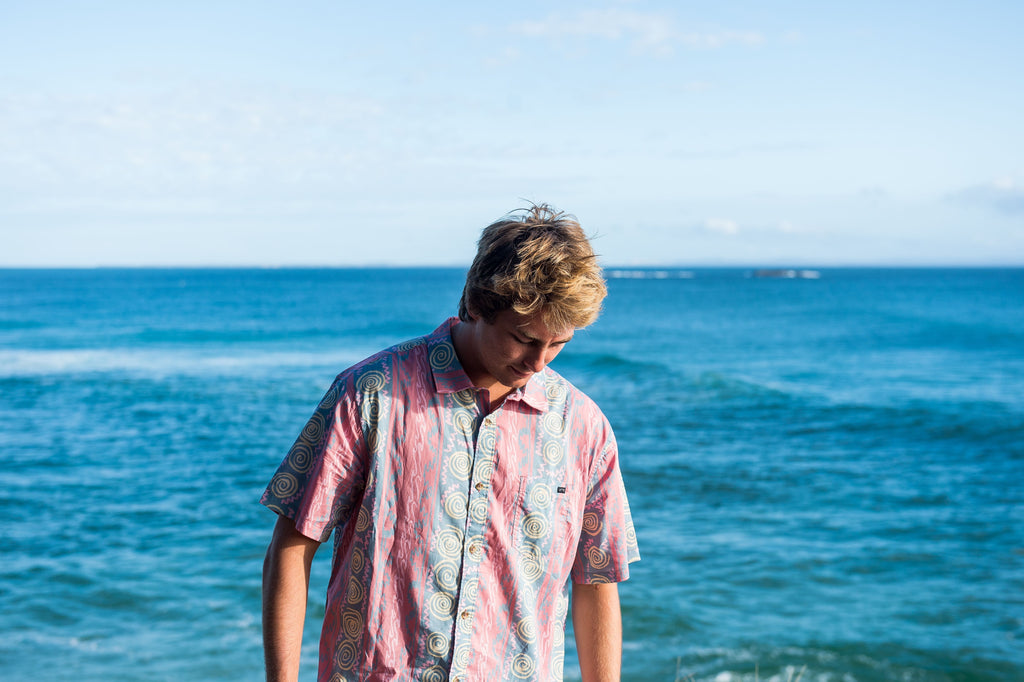 Photo shoot of a woven shirt, ocean background.